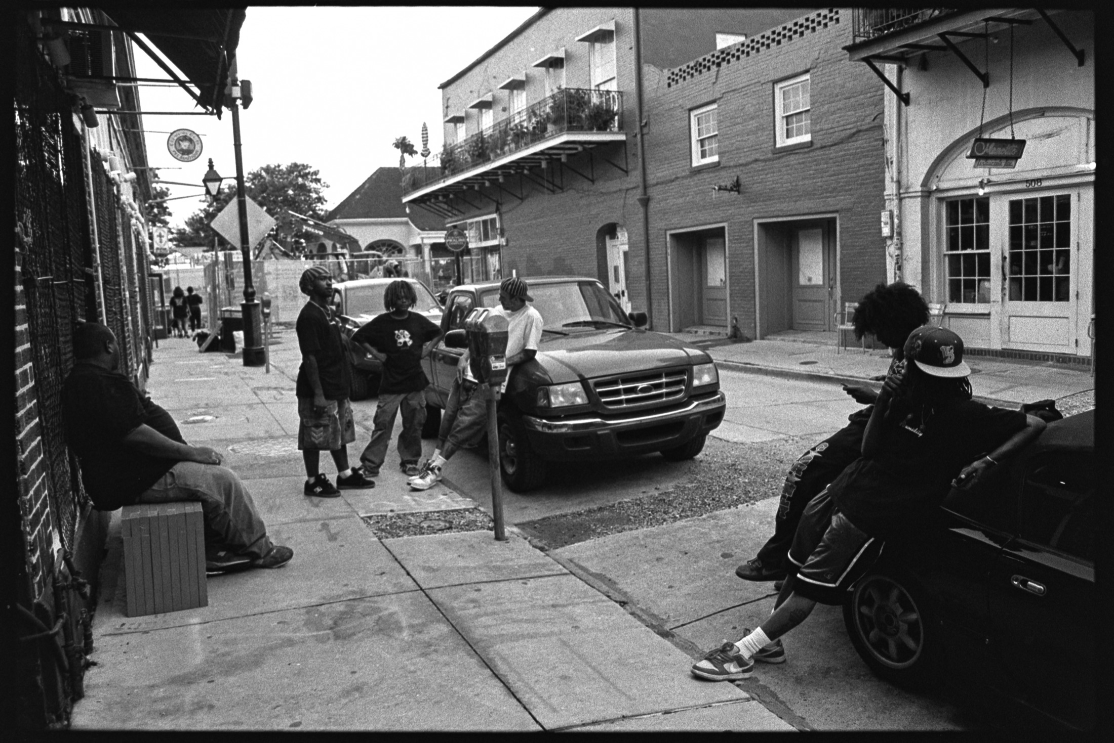 Street Star crew gathered on a New Orleans sidewalk around cars